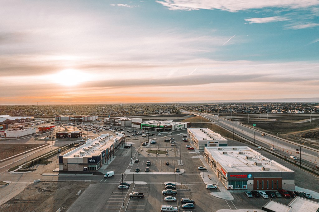 an aerial view of an airport parking lot with cars and trucks