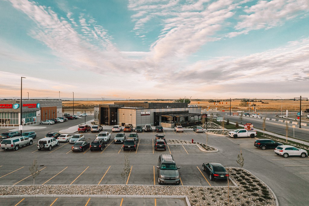 a parking lot at an airport with cars parked in it