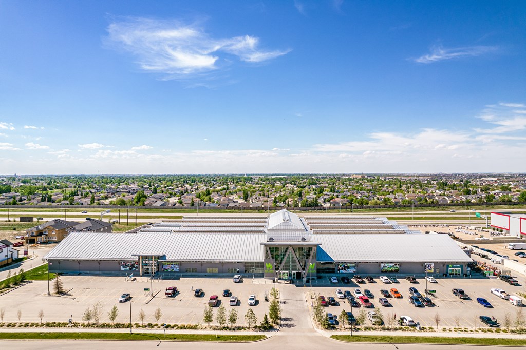 an aerial view of a building with cars parked in front of it