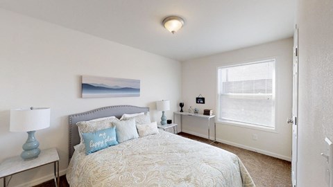 a bedroom with a bed and a window