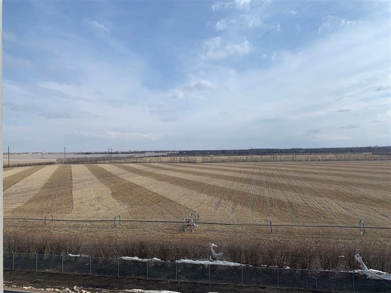 an empty field with a fence in front of it