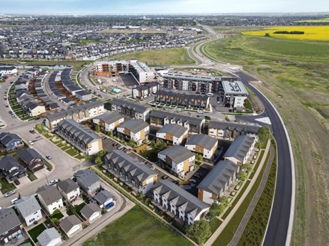 A large housing development with a curved road running through it.