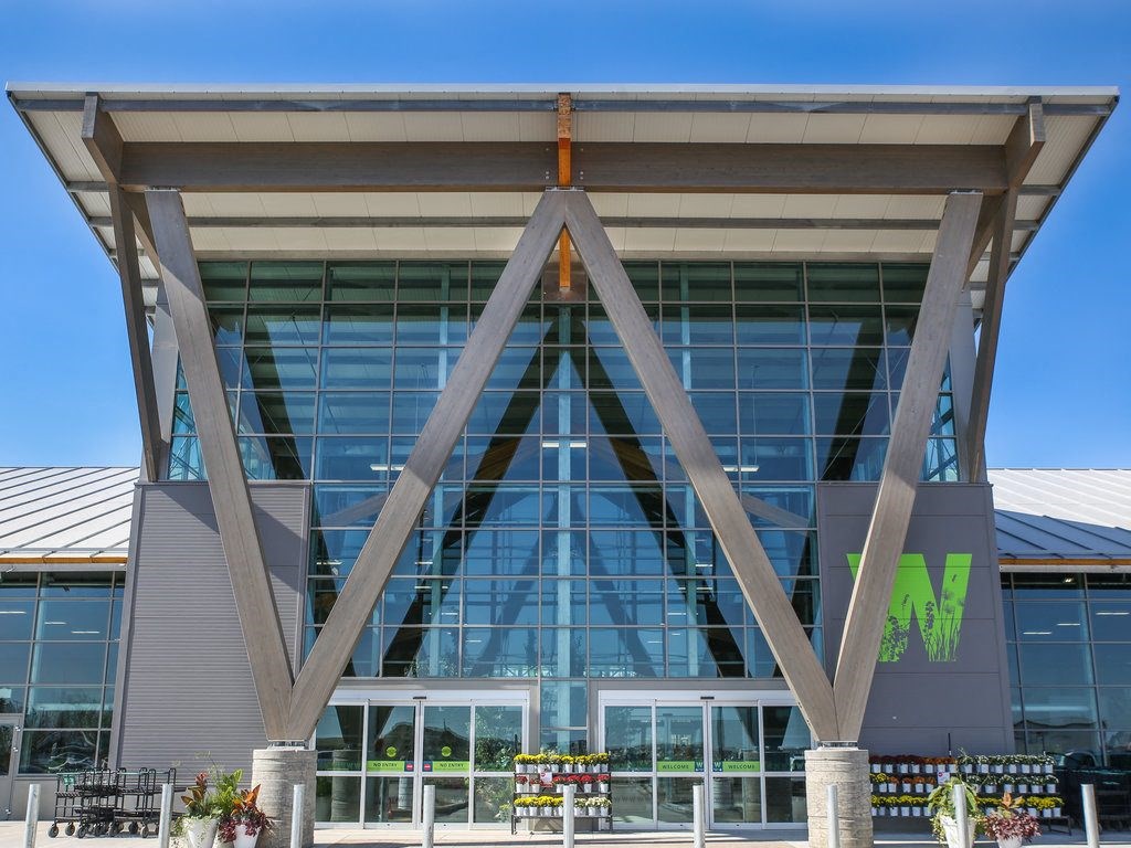 the front of a building with large glass windows and a mms logo