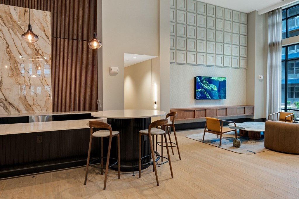 a seating area with a round table and chairs in a lobby at Preston Ridge, Cary, 27513