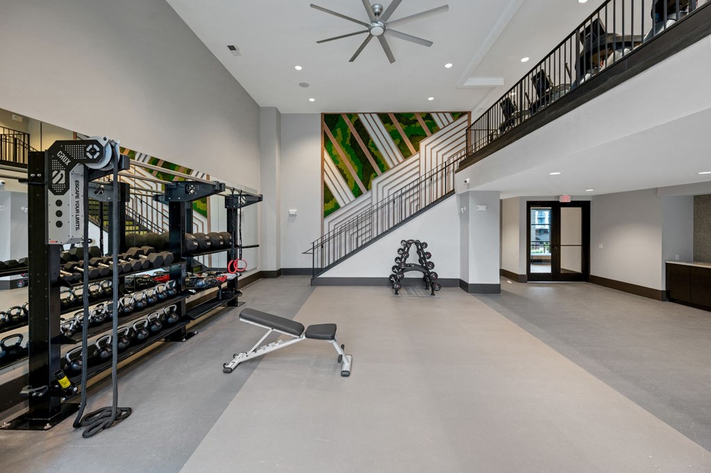 the home has a workout room with a staircase and a wall of wine racks at Preston Ridge, North Carolina, 27513