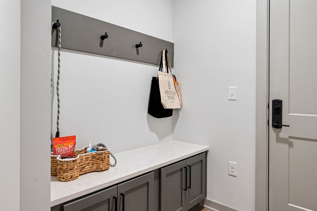 the laundry room has a counter top and a door to the closet at Preston Ridge, Cary, NC