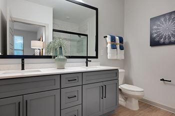 a white bathroom with a large mirror and a toilet at Preston Ridge, Cary, 27513