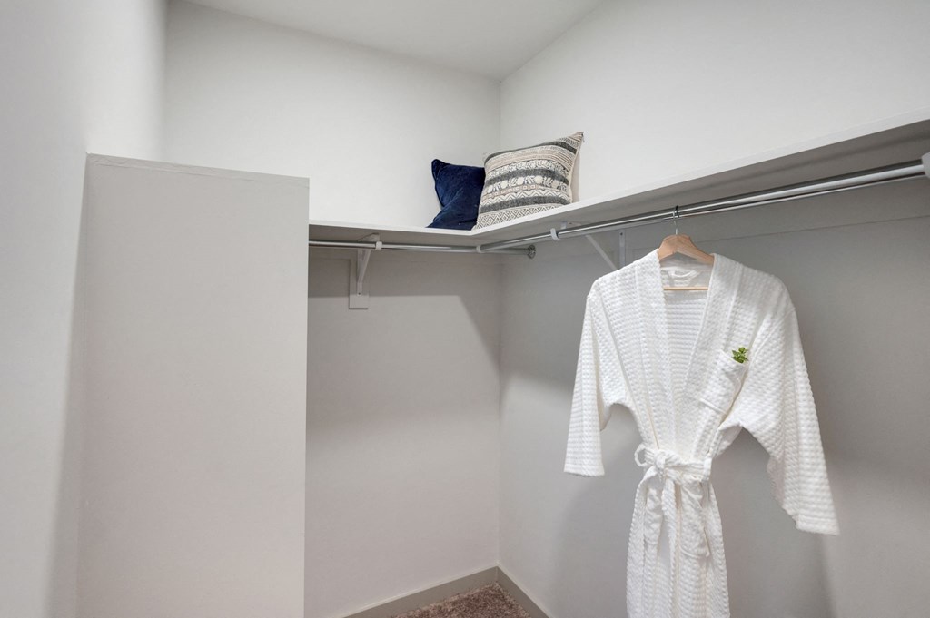 a white robe hanging on a hangar in a closet at Preston Ridge, Cary, 27513