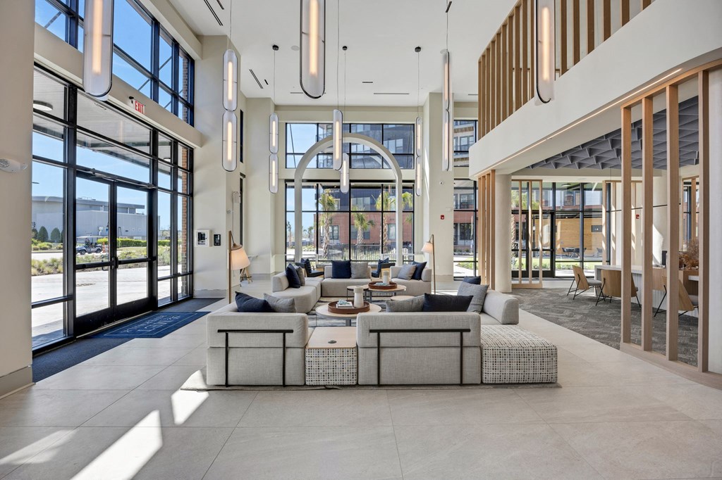 a large living room with a large couch and a table at Metropolitan at the Riverwalk, Wilmington, NC