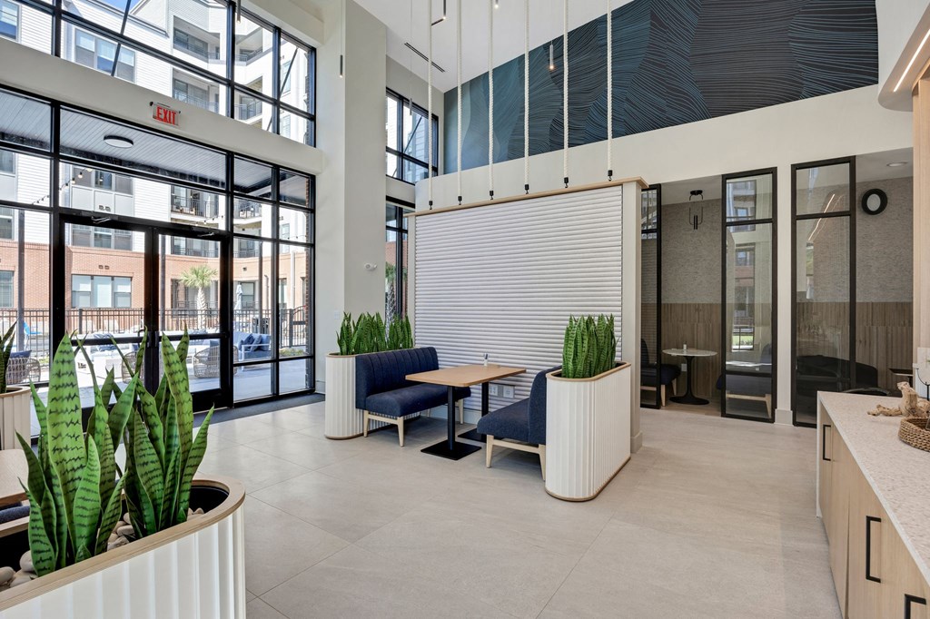 the lobby of a building with chairs and a table at Metropolitan at the Riverwalk, Wilmington, NC