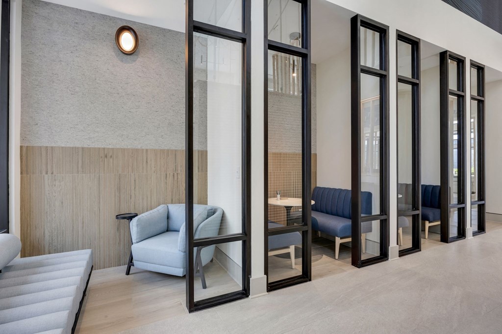 a room with mirrors and chairs and a couch at Metropolitan at the Riverwalk, Wilmington, NC