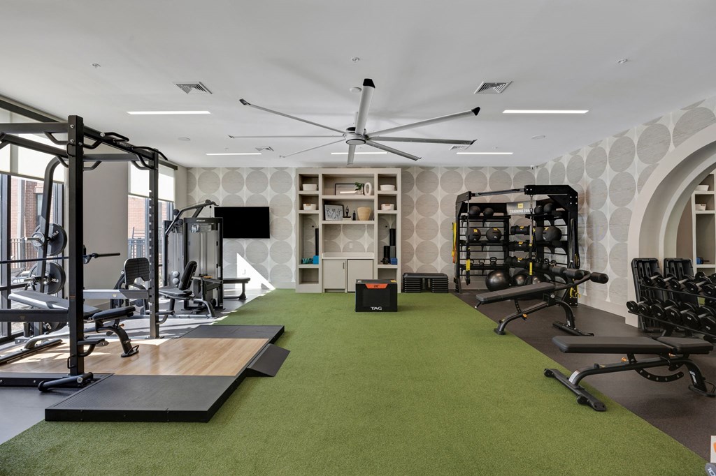a gym with exercise equipment and green carpet at Metropolitan at the Riverwalk, Wilmington, NC