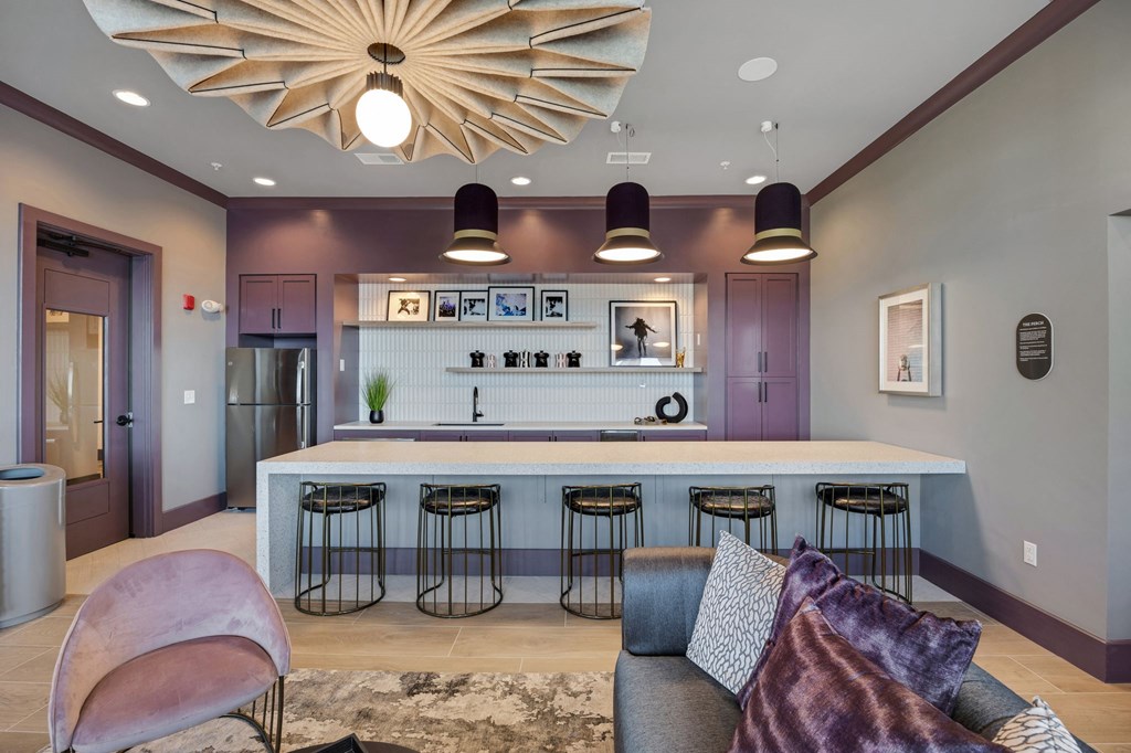 a living room with a bar and a kitchen at Metropolitan at the Riverwalk, Wilmington, NC