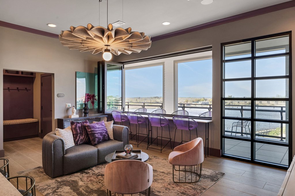 a living room with a view of a dining room and a bar at Metropolitan at the Riverwalk, Wilmington, NC