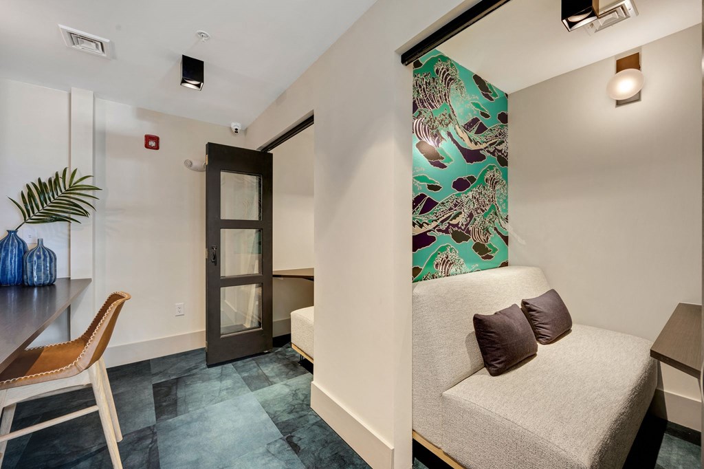 a room with a couch and a desk and a door at Metropolitan at the Riverwalk, Wilmington, NC