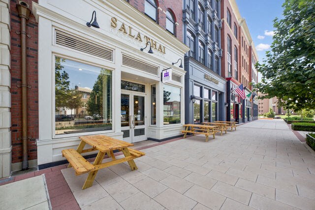 a sidewalk with picnic tables outside of a building at Park Kennedy, Washington