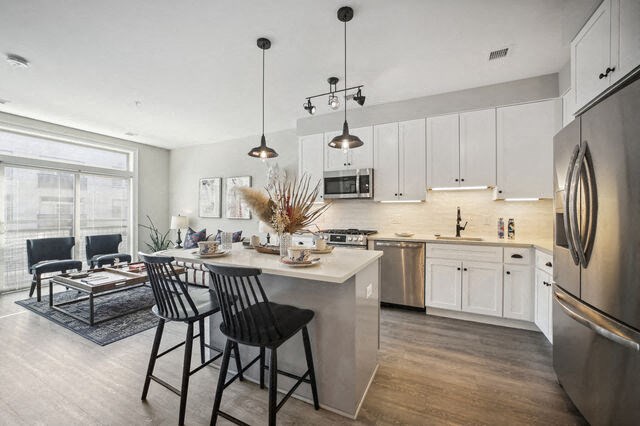 a kitchen and living room with a table and chairs at Park Kennedy, Washington, 20003