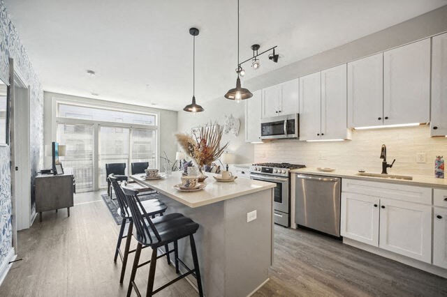 a kitchen with a large island and chairs in it at Park Kennedy, Washington, DC