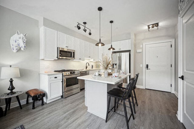 a kitchen with an island and a table with chairs at Park Kennedy, Washington, 20003