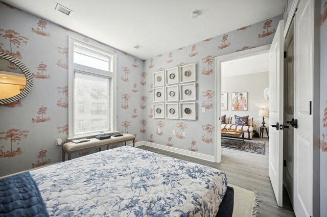 a bedroom with a bed and a wall of framed pictures at Park Kennedy, Washington, 20003