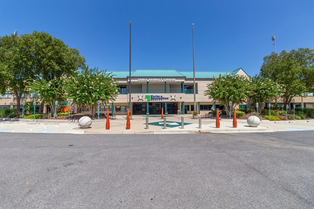 a building with a green roof and orange pillars in front of it at Fairmont at South Lake, Bowie, 20716