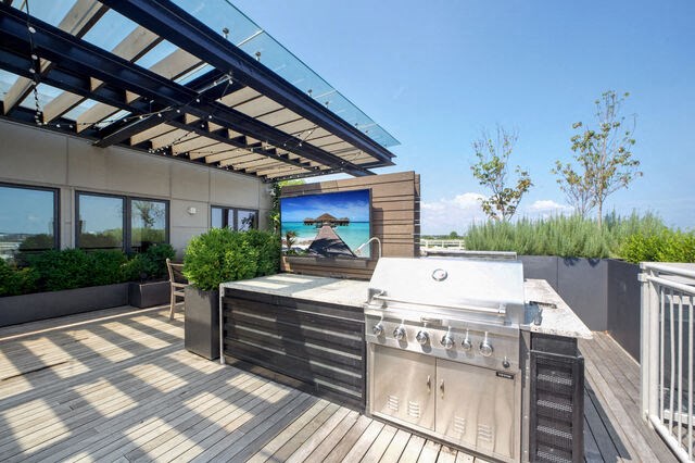 a large outdoor entertaining area with a grill and a television at Park Kennedy, Washington, 20003