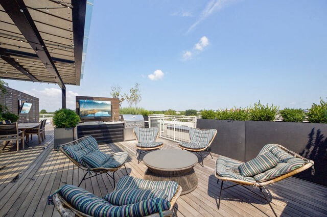 a patio with chairs and a table and a tv at Park Kennedy, Washington, DC, 20003