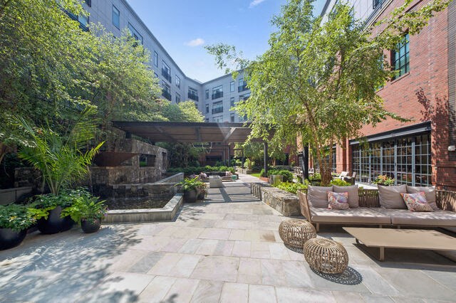 a courtyard with benches and trees and a building at Park Kennedy, Washington, DC, 20003