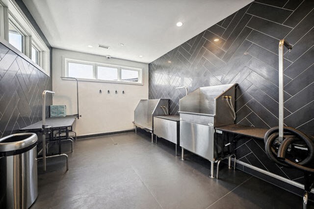 a kitchen with three stainless steel refrigerators and a table at Park Kennedy, Washington, DC