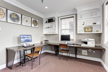 a home office with two desks and a computer at County Center Crossing Apartments in Woodbridge, VA