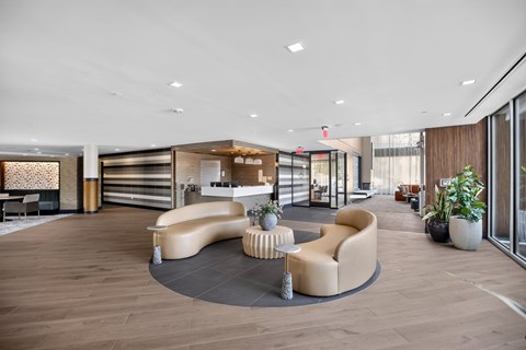 A modern living room with a curved sofa and a coffee table.