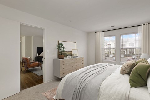 a bedroom with a bed and a dresser and a window at The Fields of Manassas