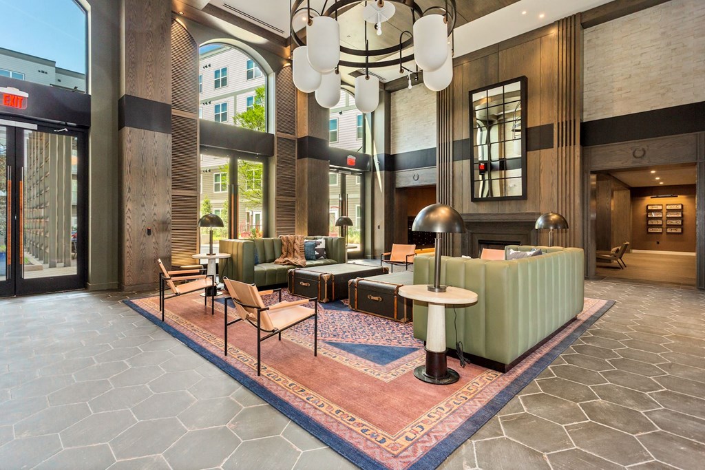 a lobby with couches and chairs and a large chandelier at Vyne One Loudoun, Ashburn