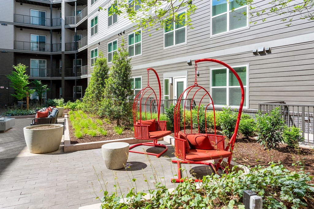 a group of red chairs sitting in front of a building at Vyne One Loudoun, Ashburn, VA, 20147