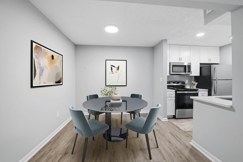 A modern dining room with a round table and grey chairs at Brampton Moors, Cary, NC, 27513