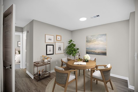 A dining room with a table set for four.
