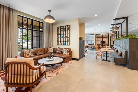 A living room with a brown chair and a brown sofa.