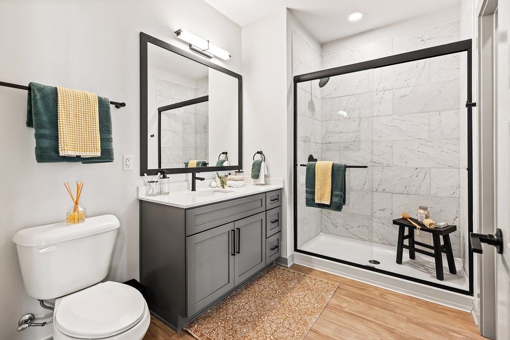 A bathroom with a white toilet and a white sink