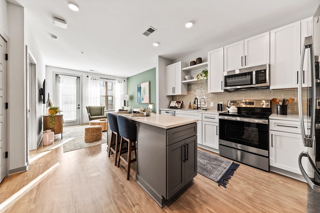 A modern kitchen with a large island and stainless steel appliances