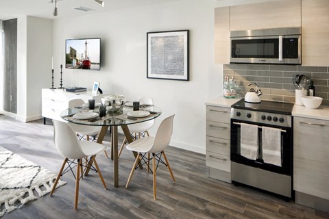 a kitchen and dining room with a table and chairs