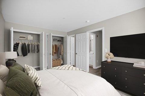 A bedroom with a large bed and a black dresser.