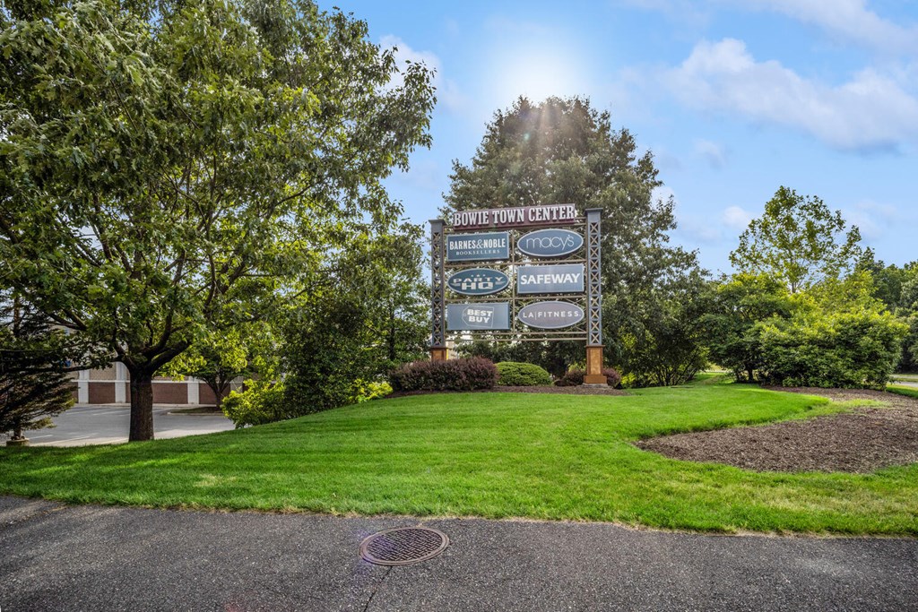 a large sign in front of a grassy area with trees at Fairmont at South Lake, Bowie, MD 20716