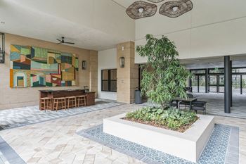a lobby with a garden and a painting on the wall  at La Unión, Tampa, 33605