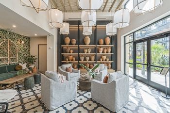 a lobby with chairs and a wall filled with vases at La Unión, Tampa, 33605