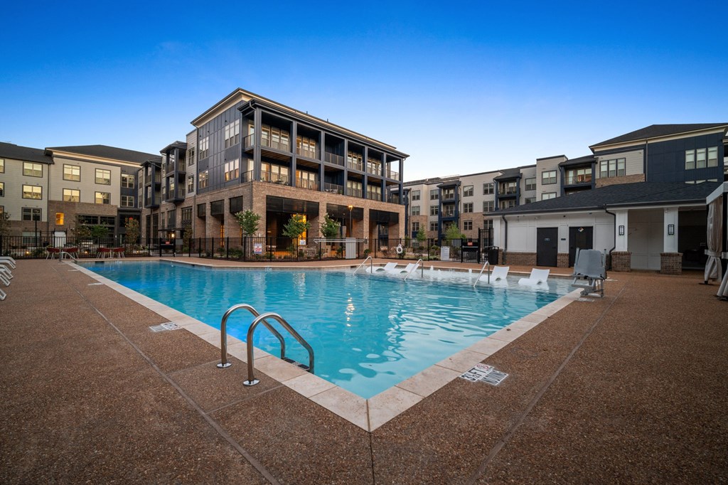 a swimming pool in front of an apartment building