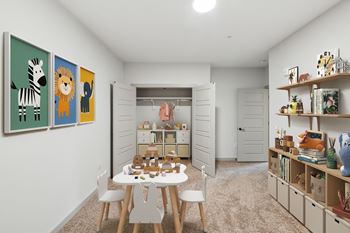 A room with a white table and chairs, a bookshelf, and a wall with animal paintings.