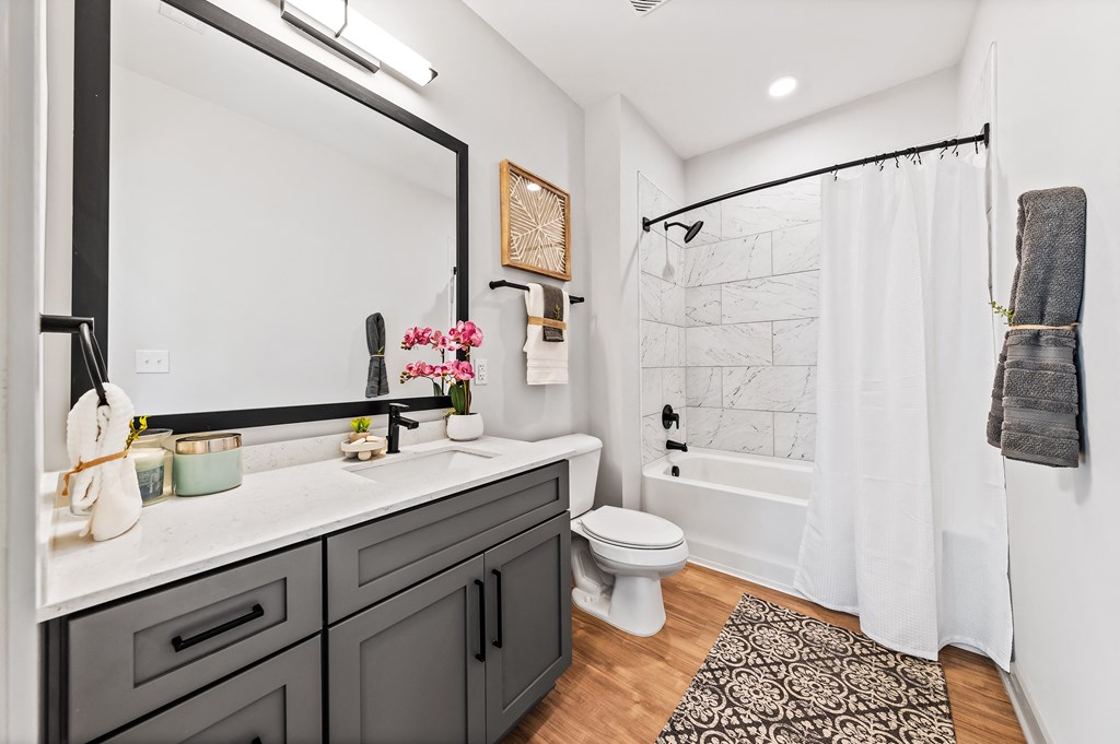 A bathroom with a white toilet and a white shower curtain
