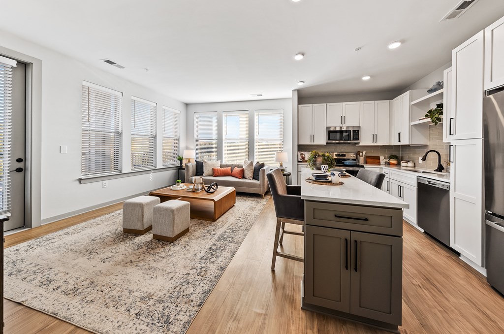 A modern kitchen with a dining area and a living room