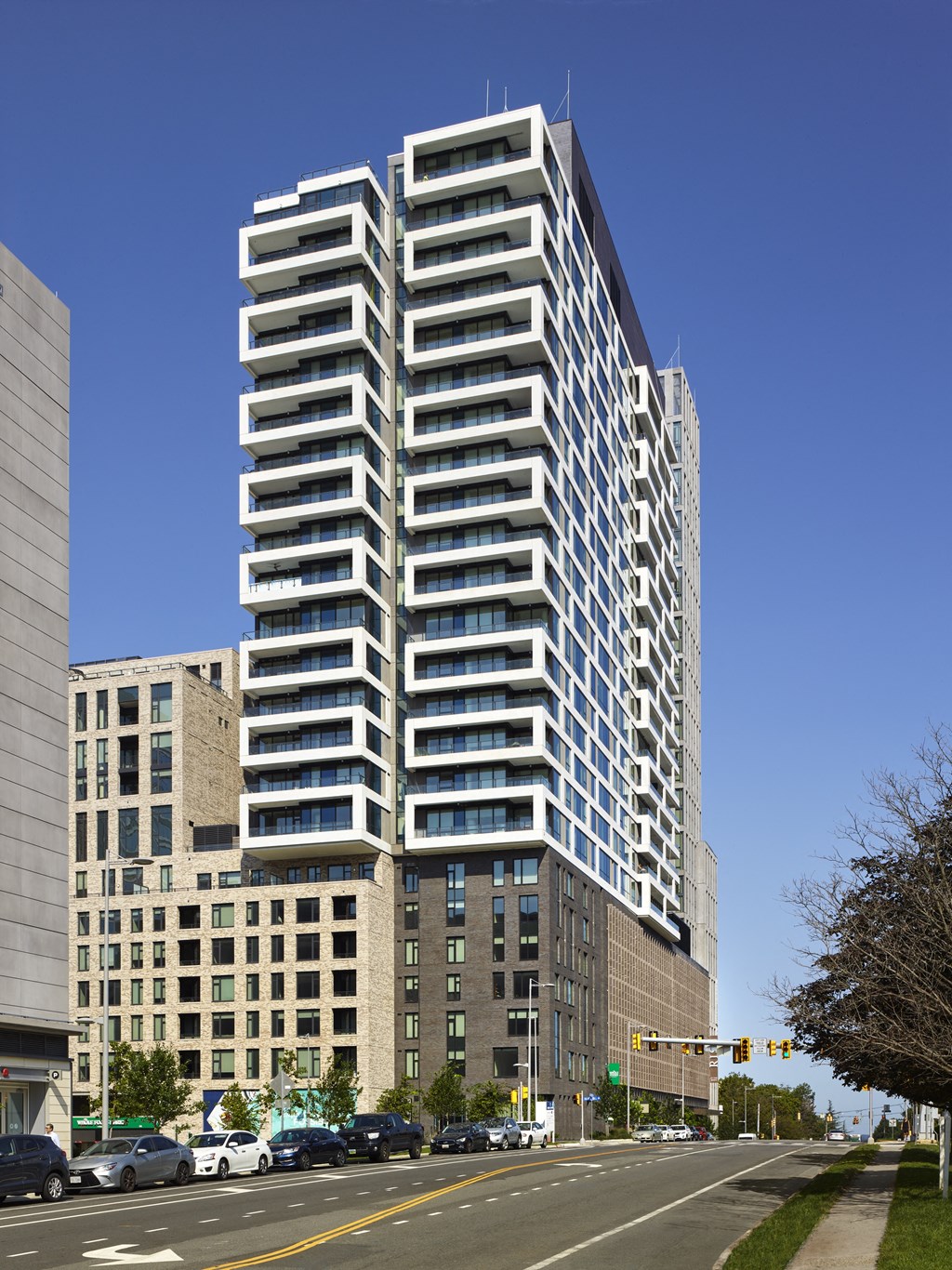 a tall building with many balconies and a blue sky in the background at The Boro, Virginia