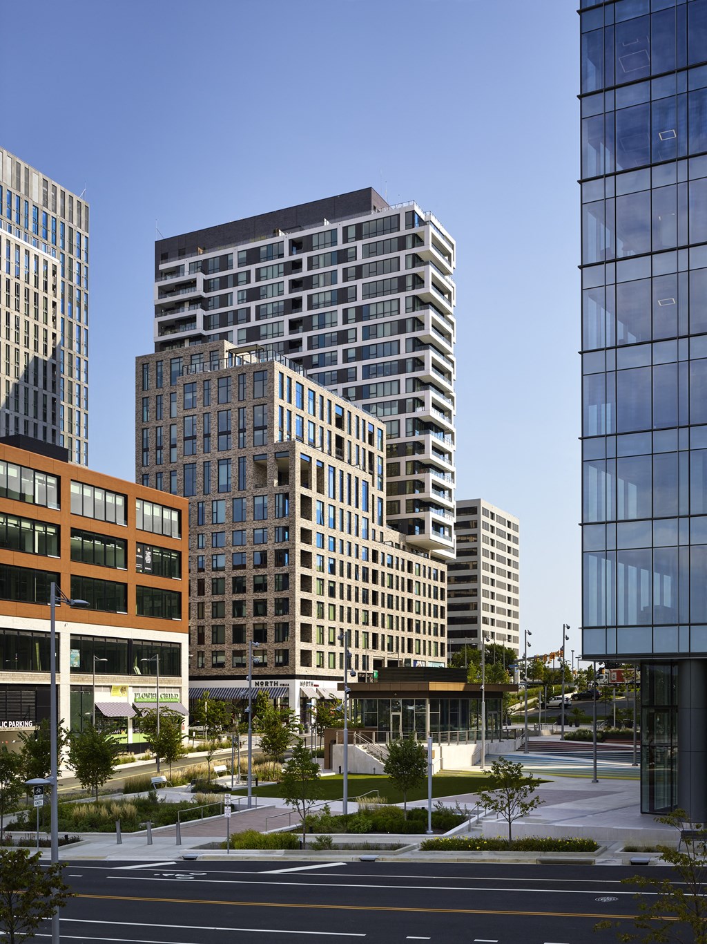 a cityscape with tall buildings and a street in the foreground at The Boro, Tysons, VA 22102